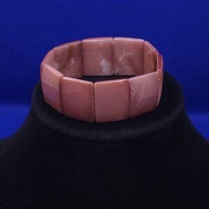 pink mother-of-pearl shell stretch bracelet featuring flat, rectangular beads.